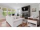 Bright living room with modern fireplace, comfortable seating, and natural light at 10993 Liberation Trce, Noblesville, IN 46060