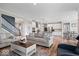 Open-concept living area with hardwood floors, comfortable seating, and a modern kitchen view at 10993 Liberation Trce, Noblesville, IN 46060