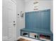 Functional mudroom with built-in bench, storage compartments, and coat hooks near the entrance at 10993 Liberation Trce, Noblesville, IN 46060