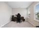 Bright office space featuring neutral walls, a desk setup, and natural light from two windows at 10993 Liberation Trce, Noblesville, IN 46060