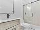Modern bathroom featuring a sleek vanity, toilet, and a glass-enclosed shower at 1100 English Ave, Indianapolis, IN 46203