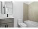 Bathroom with stylish vanity, a toilet, and shower/tub combo at 1100 English Ave, Indianapolis, IN 46203