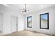 Bright, minimalist bedroom with hardwood floors, modern lighting, and two windows at 1100 English Ave, Indianapolis, IN 46203
