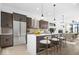 Beautiful eat-in kitchen with a central island, stainless steel appliances, and dark wood cabinetry at 1100 English Ave, Indianapolis, IN 46203