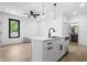 Stylish eat-in kitchen features an island with sink and a modern faucet under pendant lighting at 1100 English Ave, Indianapolis, IN 46203