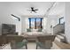 Bright living room with sleek ceiling fan, recessed lighting, and large windows offering neighborhood views at 1100 English Ave, Indianapolis, IN 46203