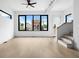 Bright, airy living room with hardwood floors, large windows, and modern staircase at 1100 English Ave, Indianapolis, IN 46203