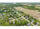 A picturesque neighborhood with mature trees, well-kept lawns, and a variety of home styles sits near a lake and farmland at 113 Spring Creek Ct, Noblesville, IN 46062