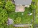An aerial view of the backyard features a wooden deck, mature trees, a well-maintained lawn, and a play set at 113 Spring Creek Ct, Noblesville, IN 46062