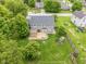 A bird's eye view captures a home's wooden deck, play set, and a large backyard with mature trees in a Gathering-friendly neighborhood at 113 Spring Creek Ct, Noblesville, IN 46062