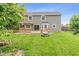 Backyard view showcases a wooden deck, and a well-maintained lawn at 113 Spring Creek Ct, Noblesville, IN 46062