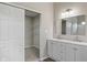 Bathroom with dual-sink vanity, a large mirror, and a convenient walk-in closet for ample storage at 113 Spring Creek Ct, Noblesville, IN 46062