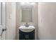 Elegant powder room featuring stylish vanity, framed mirror, and contemporary fixtures, offering a touch of sophistication at 113 Spring Creek Ct, Noblesville, IN 46062