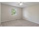 A simple, neutral bedroom features a window providing natural light at 113 Spring Creek Ct, Noblesville, IN 46062