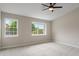 Bright bedroom features two large windows, neutral carpet and fresh paint, creating a peaceful and inviting atmosphere at 113 Spring Creek Ct, Noblesville, IN 46062