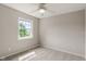A simple, neutral bedroom features a window providing natural light at 113 Spring Creek Ct, Noblesville, IN 46062