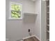 A small closet with a window and shelves for storing items at 113 Spring Creek Ct, Noblesville, IN 46062