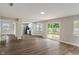 Spacious living room featuring recessed lighting, fresh paint, and a seamless transition into the modern kitchen at 113 Spring Creek Ct, Noblesville, IN 46062
