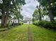 Backyard lawn with a narrow pathway leading to a white-painted home at 1137 W 34Th St, Indianapolis, IN 46208