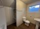 Bathroom featuring a toilet, pedestal sink, and built-in shelving at 1137 W 34Th St, Indianapolis, IN 46208