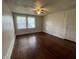 Bedroom with hardwood floors, ceiling fan, and window letting in natural light at 1137 W 34Th St, Indianapolis, IN 46208