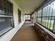 Enclosed front porch with brick accent wall, windows and neutral rug at 1137 W 34Th St, Indianapolis, IN 46208