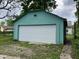 A standalone one-car garage with a white door and painted in a light turquoise color at 1137 W 34Th St, Indianapolis, IN 46208