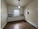 Functional kitchen featuring white cabinets, tile countertops and a window for natural light at 1137 W 34Th St, Indianapolis, IN 46208