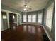 Living room with hardwood floors, a ceiling fan, and generous natural light at 1137 W 34Th St, Indianapolis, IN 46208