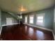 Spacious living room featuring hardwood floors, an adjacent staircase, and natural lighting at 1137 W 34Th St, Indianapolis, IN 46208