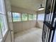 Sunroom featuring an array of windows, bright natural light, and painted wood floor at 1137 W 34Th St, Indianapolis, IN 46208
