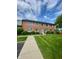 Charming brick building with manicured lawn and inviting blue door at 1150 Canterbury Ct # Apt D, Indianapolis, IN 46260