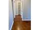 Hallway with hardwood floors and doors leading to rooms at 1150 Canterbury Ct # Apt D, Indianapolis, IN 46260