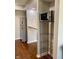 Galley kitchen with stainless steel appliances, hardwood floor, and microwave at 1150 Canterbury Ct # Apt D, Indianapolis, IN 46260