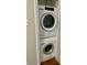 Convenient laundry room with stacked washer and dryer appliances at 1150 Canterbury Ct # Apt D, Indianapolis, IN 46260