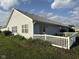 Home exterior featuring well maintained lawn and a white picket fence at 11523 Coastal Way, Indianapolis, IN 46229