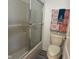 Bathroom featuring a walk-in shower with glass doors and decorated towel rack at 11523 Coastal Way, Indianapolis, IN 46229