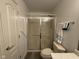 Bathroom showcasing a toilet and shower with sliding glass doors at 11523 Coastal Way, Indianapolis, IN 46229
