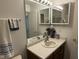 Bathroom featuring a vanity, decorative mirror, and ample lighting fixture at 11523 Coastal Way, Indianapolis, IN 46229