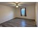 Bedroom featuring gray wood flooring and a ceiling fan with a light fixture at 11523 Coastal Way, Indianapolis, IN 46229