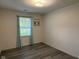 Bedroom featuring gray wood flooring and a window with teal curtains at 11523 Coastal Way, Indianapolis, IN 46229