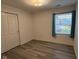Bedroom with a window featuring curtains and a closet at 11523 Coastal Way, Indianapolis, IN 46229