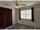 View of the bedroom featuring new flooring, a ceiling fan, and a large window at 11523 Coastal Way, Indianapolis, IN 46229