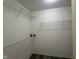 Walk-in closet with metal shelving and gray wood flooring at 11523 Coastal Way, Indianapolis, IN 46229