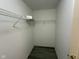 Walk-in closet with metal shelving and gray wood flooring at 11523 Coastal Way, Indianapolis, IN 46229