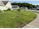 A well-maintained lawn features a young tree and access to sidewalks at 11523 Coastal Way, Indianapolis, IN 46229
