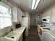 View of kitchen featuring white appliances and laminate flooring at 11523 Coastal Way, Indianapolis, IN 46229