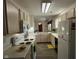 Galley kitchen with white appliances, countertops, and cabinets at 11523 Coastal Way, Indianapolis, IN 46229