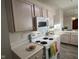 Galley kitchen with white appliances, countertops, and cabinets at 11523 Coastal Way, Indianapolis, IN 46229