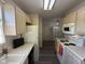 View of kitchen featuring white appliances and laminate flooring at 11523 Coastal Way, Indianapolis, IN 46229